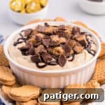 Reese's Peanut Butter Cup Dip in white serving bowl served on a platter with Nutter Butter Cookies for dipping.
