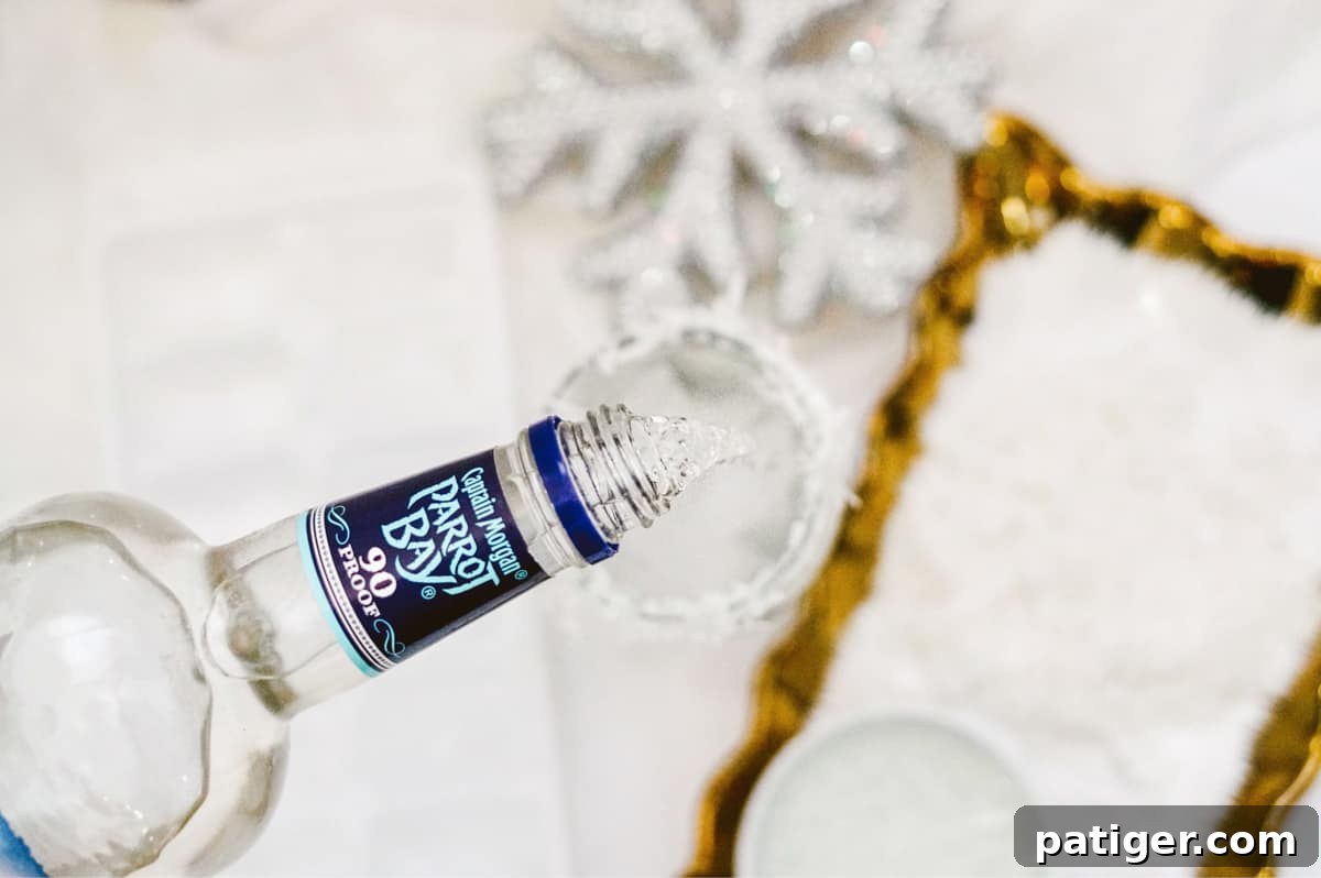 Coconut rum, specifically Captain Morgan Parrot Bay, being poured into a glass over ice.