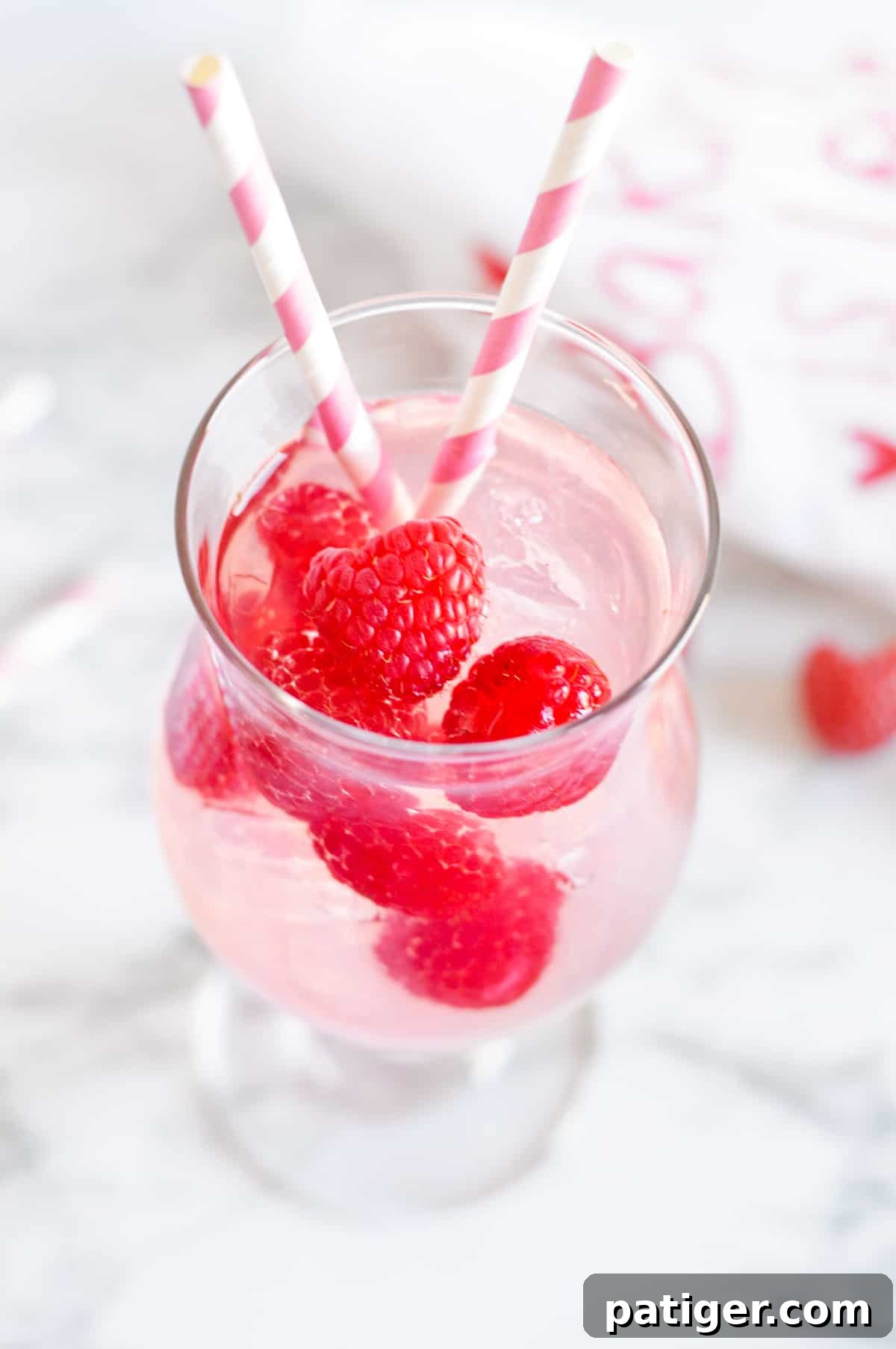 pink moscato sangria with fresh raspberries in cocktail glass