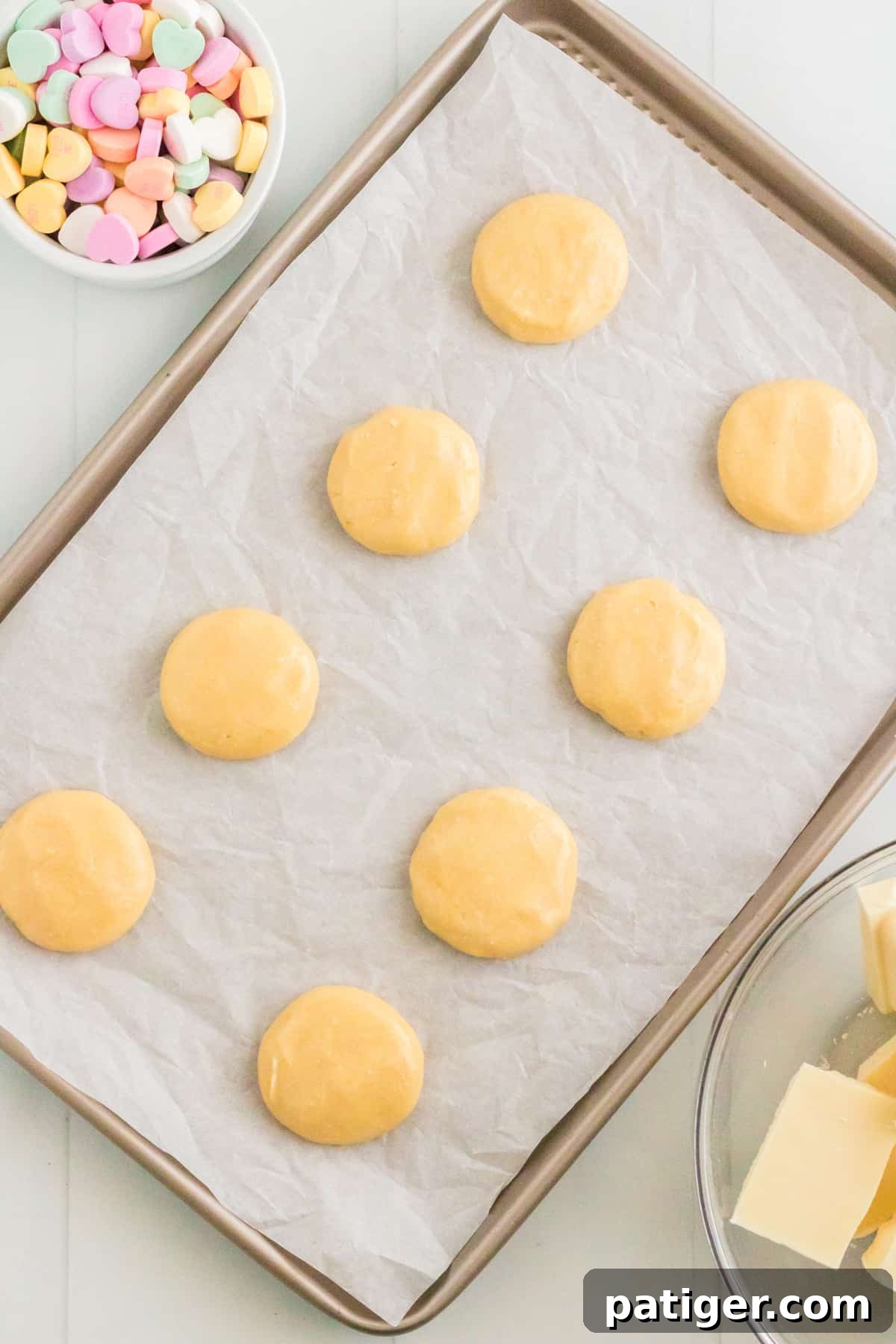 Vanilla cake mix cookie batter on parchment lined baking sheet