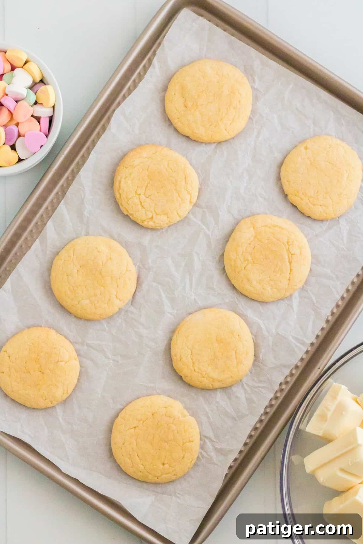 Vanilla cake mix cookies on lined cookie sheet
