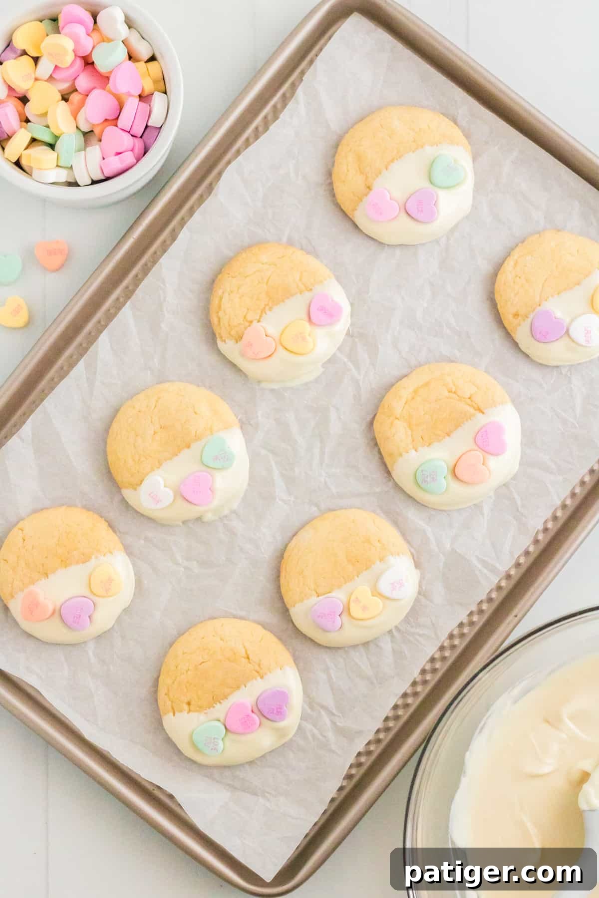 Dipped Valentines Day Conversation Heart Cookies on lined cookie sheet