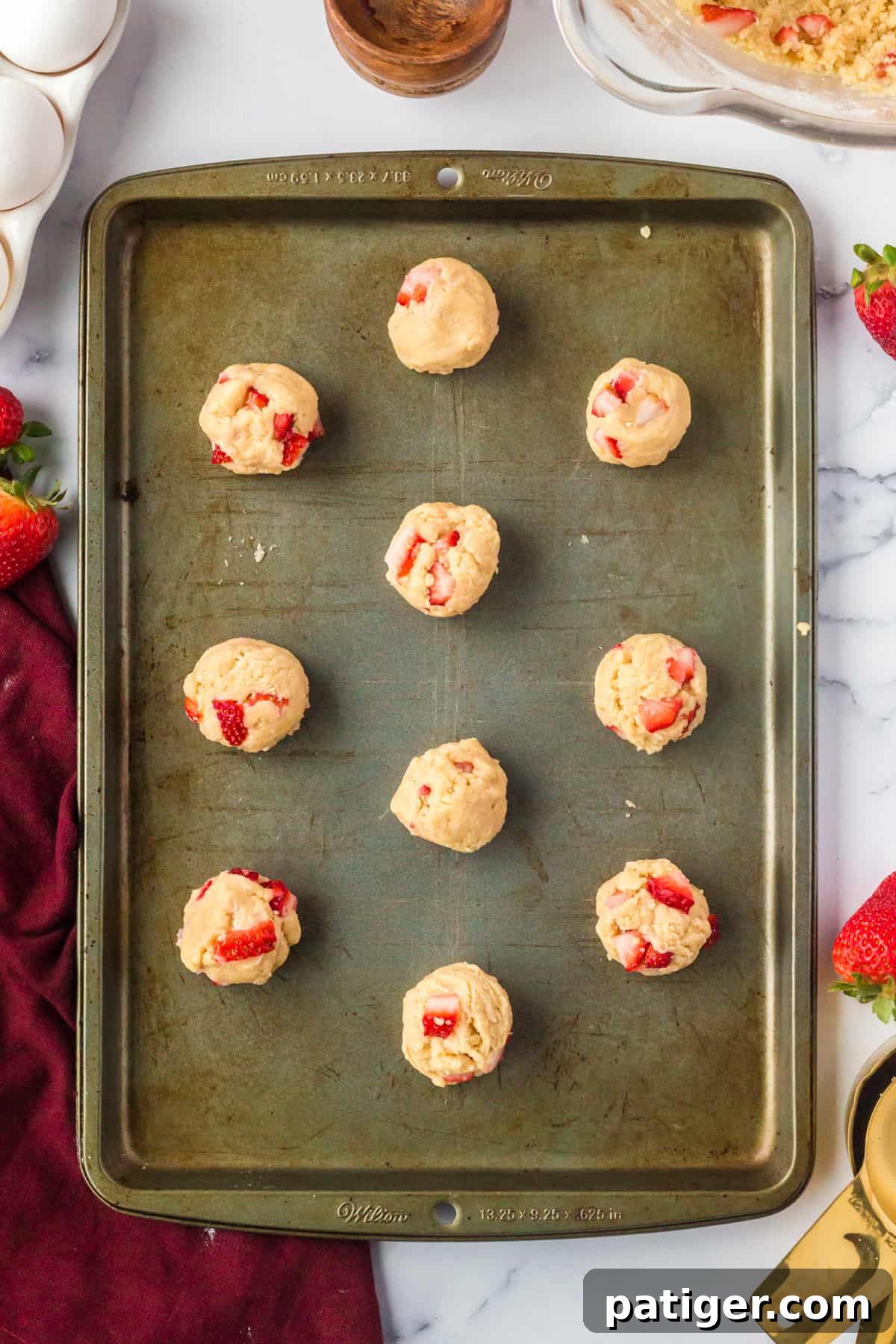 Strawberry Shortcake Cookie Bliss 10 Unbaked cookies with fresh strawberries on baking sheet