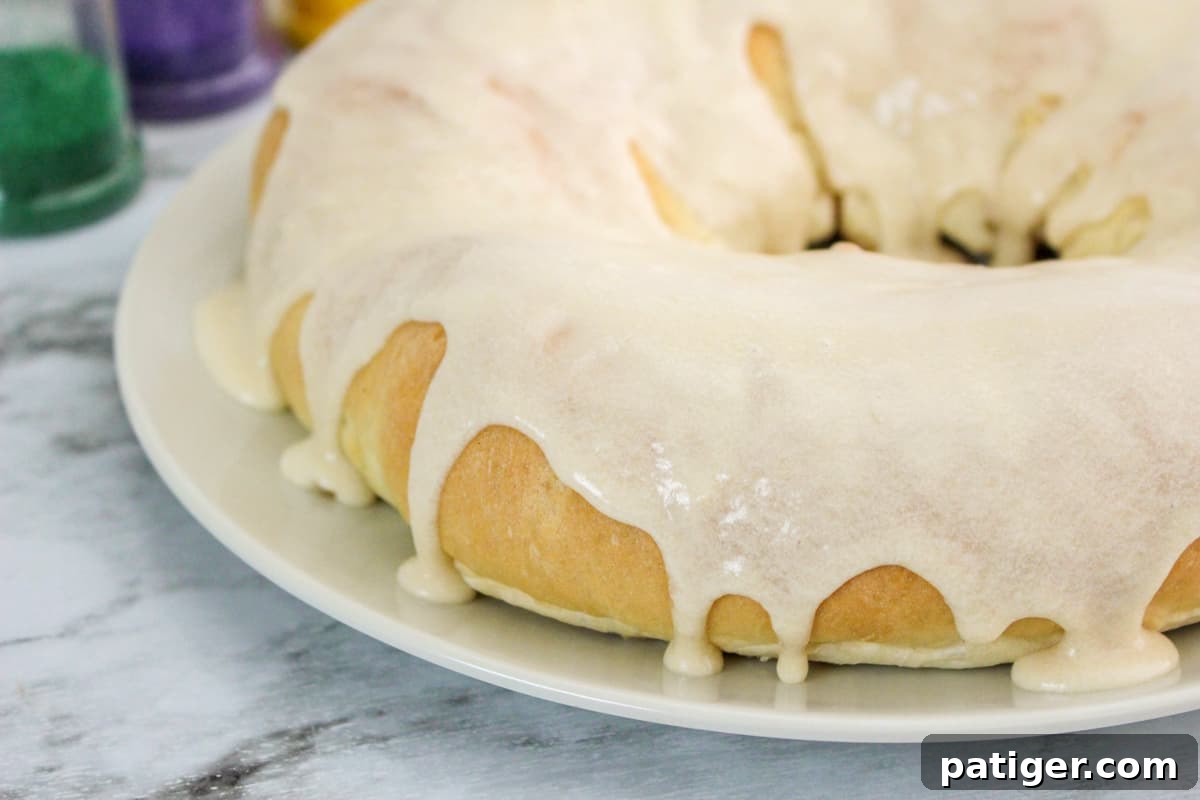 King cake with glaze poured over it and dripping down the sides.
