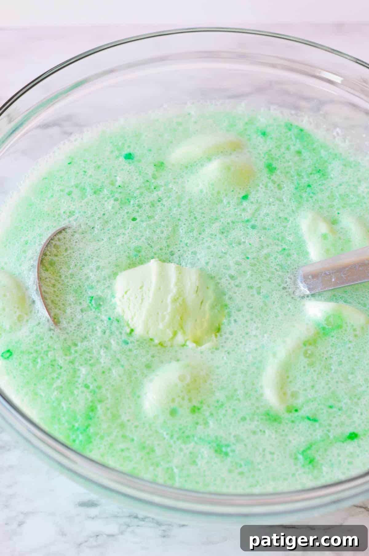 Clover Kick 5 Glass punch bowl filled with non-alcoholic green punch for St. Patrick's Day.