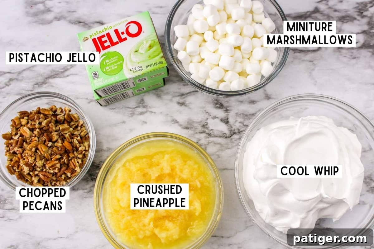 All the fresh and vibrant ingredients laid out for making Watergate Salad, including pistachio pudding mix, crushed pineapple, mini marshmallows, pecans, and whipped topping.