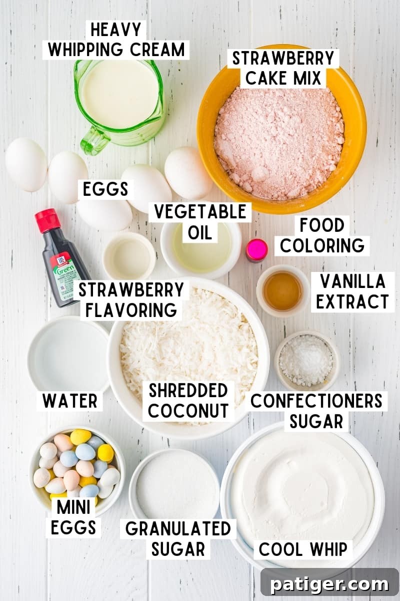 A flat lay photograph showcasing all the ingredients required for making an Easter Cake Roll, including strawberry cake mix, eggs, oil, sugar, heavy cream, extracts, and mini chocolate eggs.