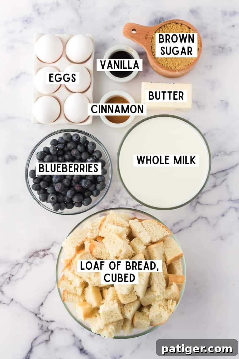A collection of ingredients for French Toast Casserole with Blueberries, including bread, milk, eggs, vanilla, and butter.