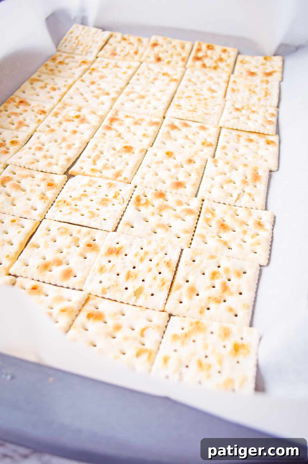 Saltine crackers on lined baking sheet