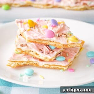 Pink white chocolate Easter bark with pastel M&Ms, Mini Eggs, and sprinkles.