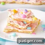 Pink white chocolate Easter bark with pastel M&Ms, Mini Eggs, and sprinkles.