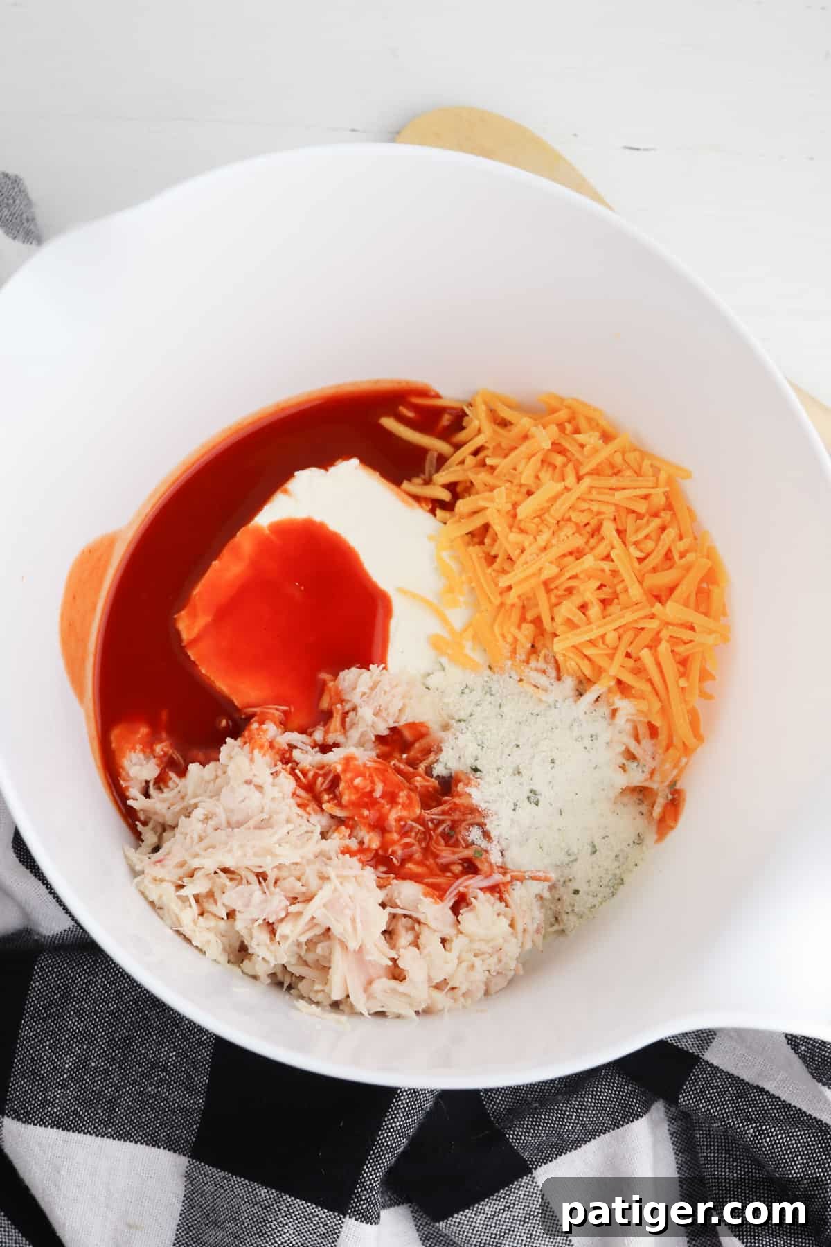 Buffalo chicken cheeseball ingredients blended in a mixing bowl.