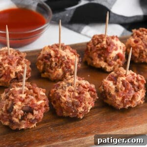 Buffalo chicken cheese balls with bacon on the outside and tooth picks sticking out on top.
