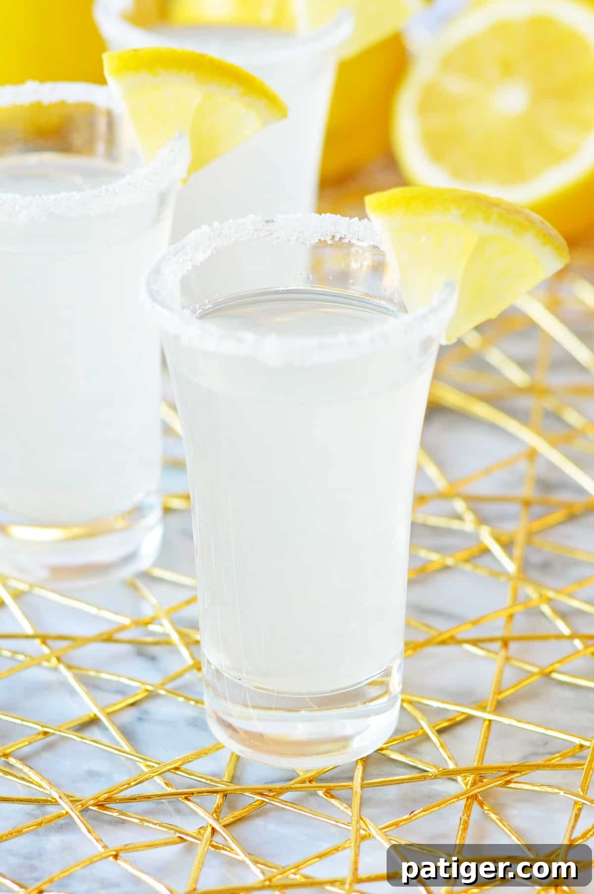 Lemon drop shot with rimmed glass and lemon garnish.