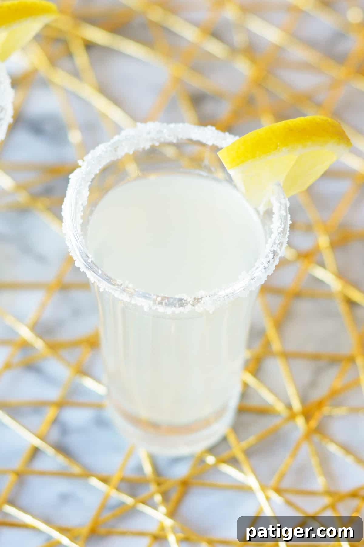 Lemon Drop Shot in 2 ounce shot glass with lemon garnish.