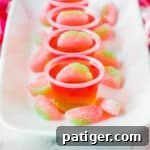 Watermelon vodka jello shots topped with sour gummy candies.