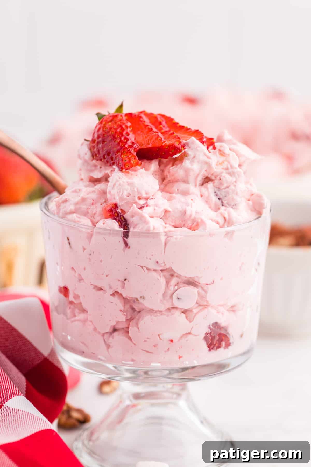 Strawberry Cloud Salad 3 Strawberry Salad Dessert in small glass, topped with sliced strawberry.