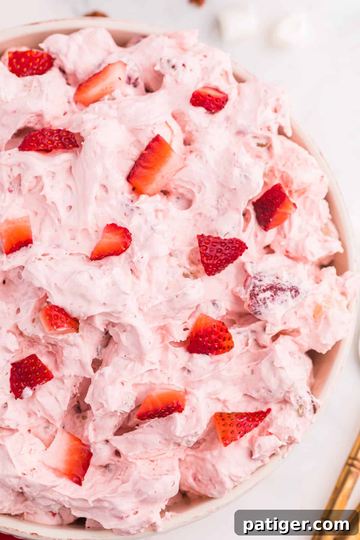 Strawberry Cloud Salad 7 Strawberry Fluff Dessert Salad in serving bowl.