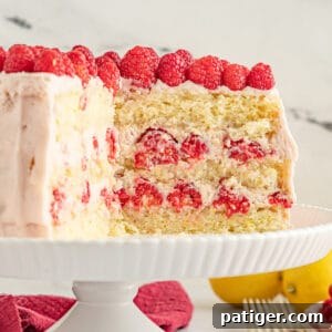 Lemon raspberry cake with three layers of yellow cake and a raspberry filling and frosting.