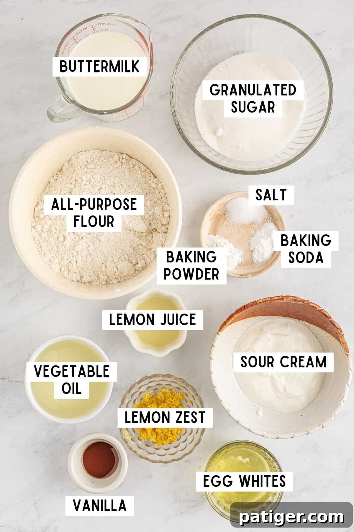 A collection of ingredients laid out for making a Raspberry Lemon Cake.