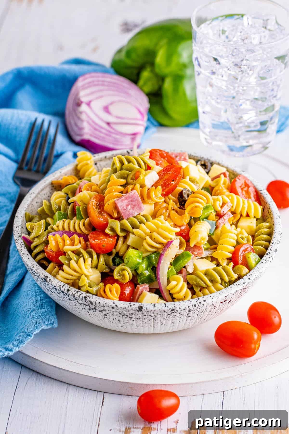 Vibrant Tri-Color Pasta Salad with Genoa Salami, Fresh Vegetables, and Homemade Italian Dressing