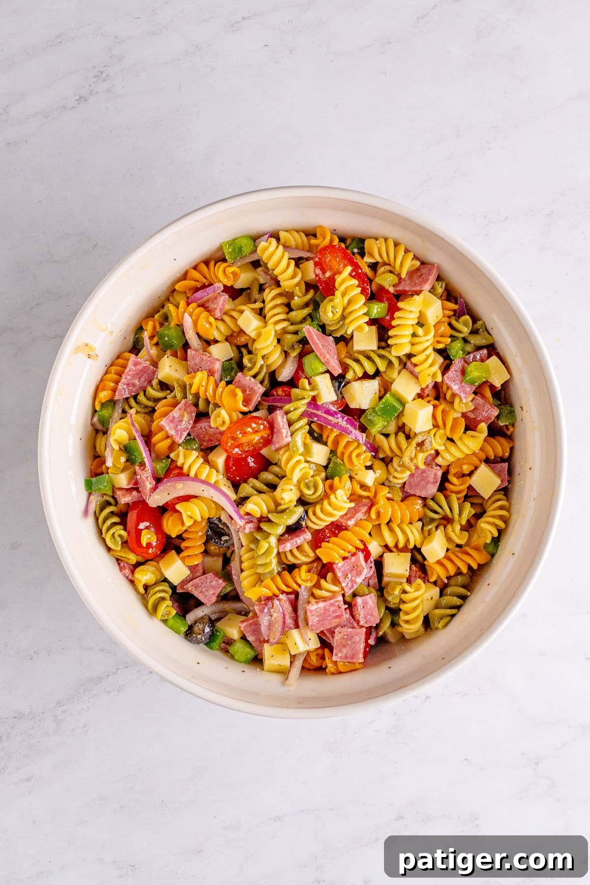 Finished Homemade Italian Pasta Salad with Salami in a bowl, after being tossed with dressing and chilled.