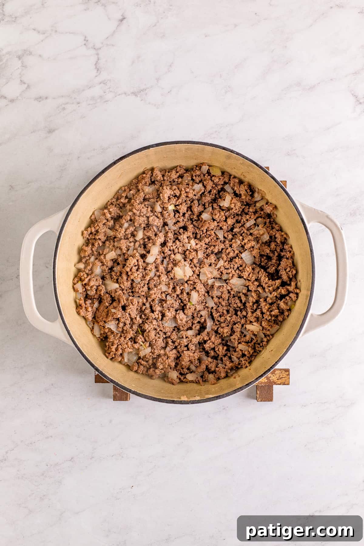 Browned ground beef and onions in large dutch oven.