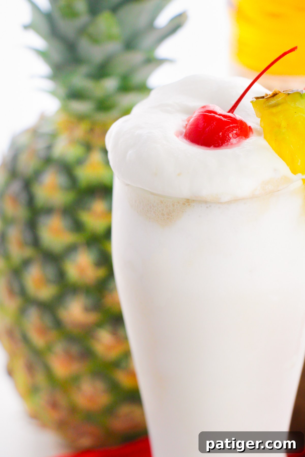 Frosty Island Escape 7 Pina colada with fresh pineapple in the background.