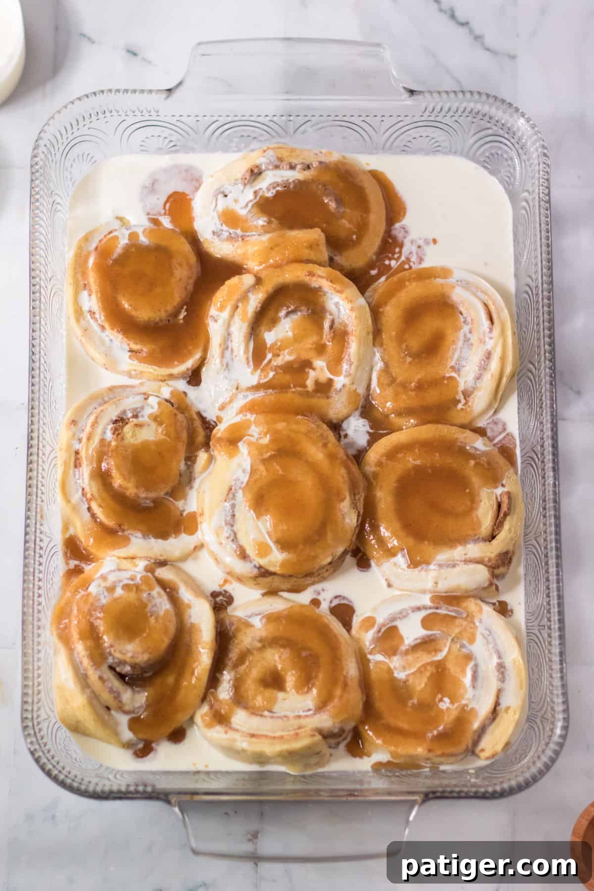 Cinnamon rolls topped with heavy cream and brown sugar cinnamon mixture.