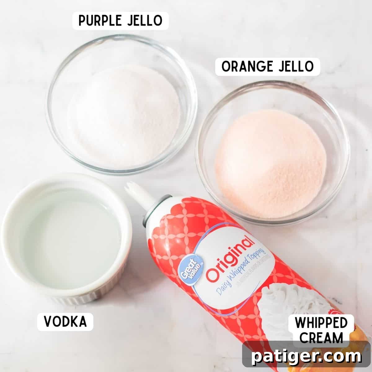 Ingredients for Halloween jello shots: orange jello mix, purple jello mix, whipped cream, and vodka.