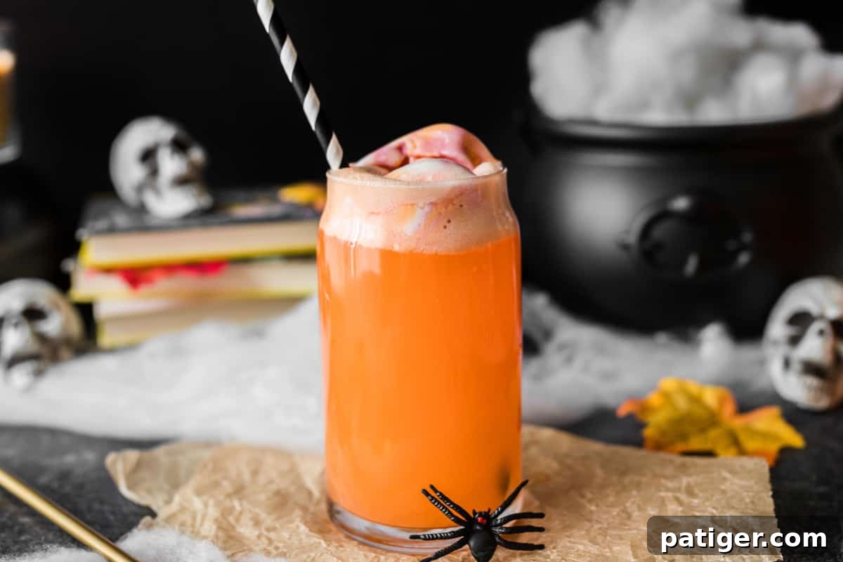 Whimsical Concoction 5 Orange hocus pocus Halloween punch for kids surrounded by Halloween decor.