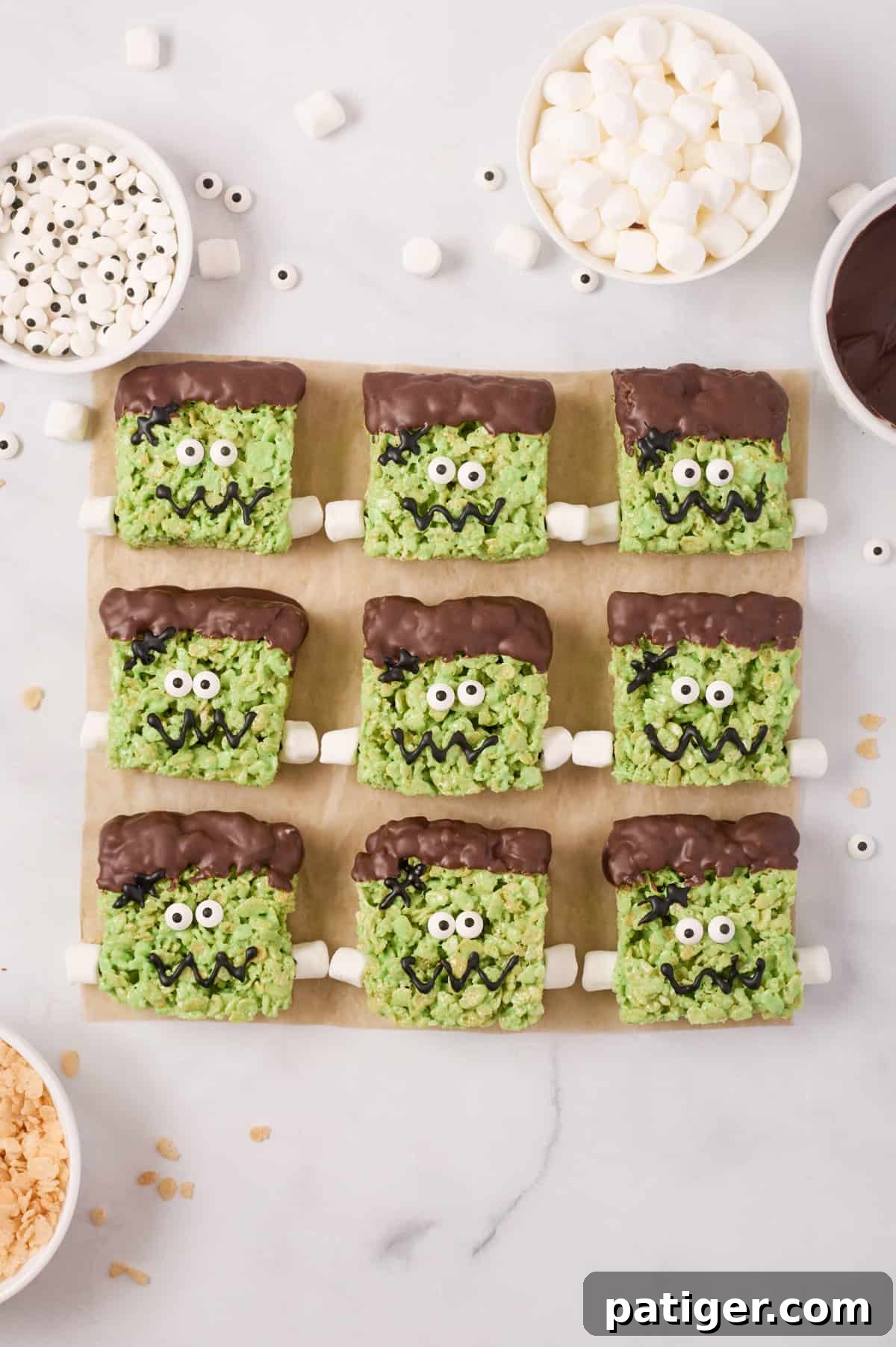 Spooktacular Frankenstein Krispies 13 Treats with mini marshmallows added on either side of bottom third to look like bolts in neck.