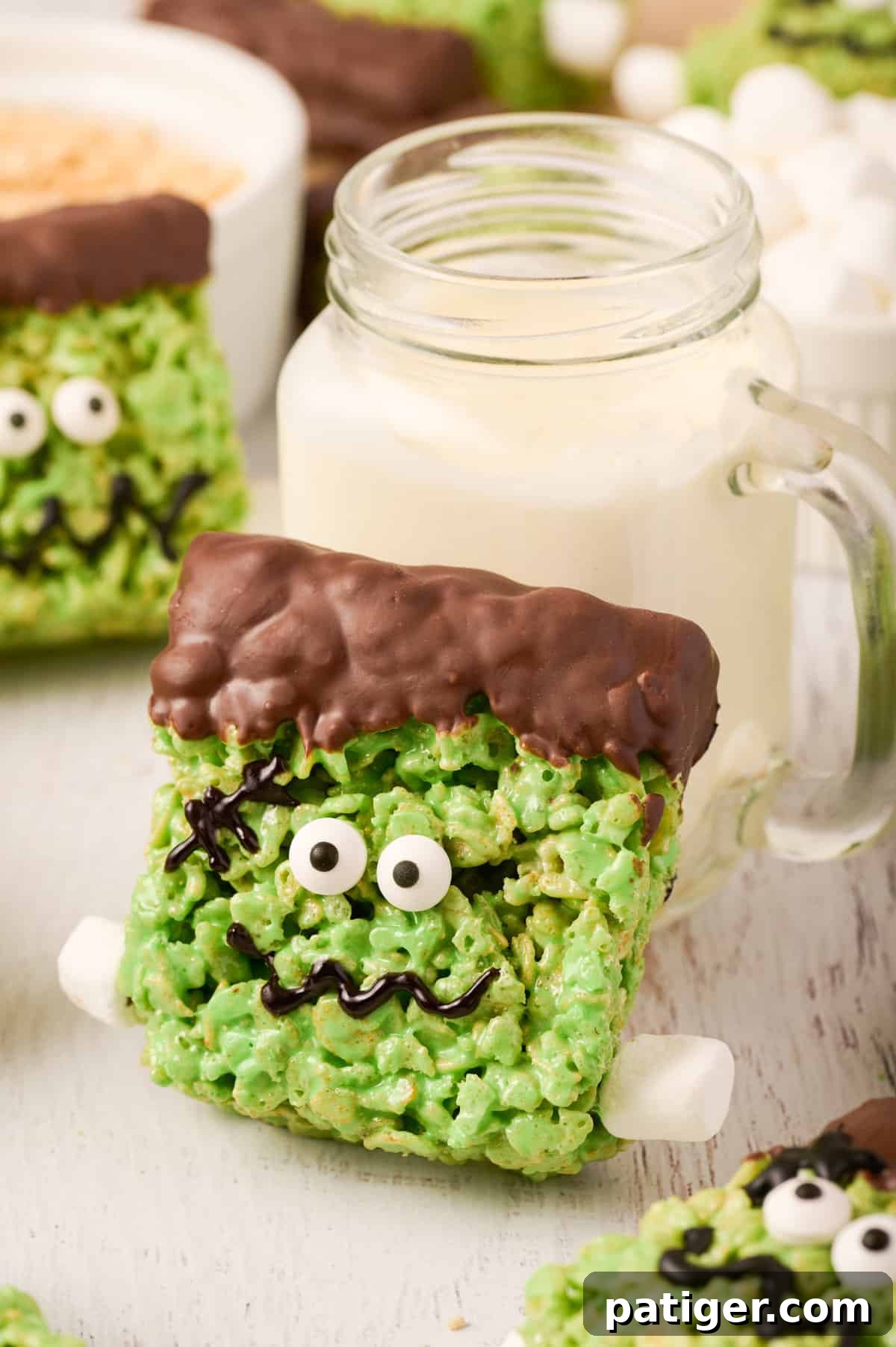 Spooktacular Frankenstein Krispies 3 Frankenstein rice krispie treat leaning against glass of milk.