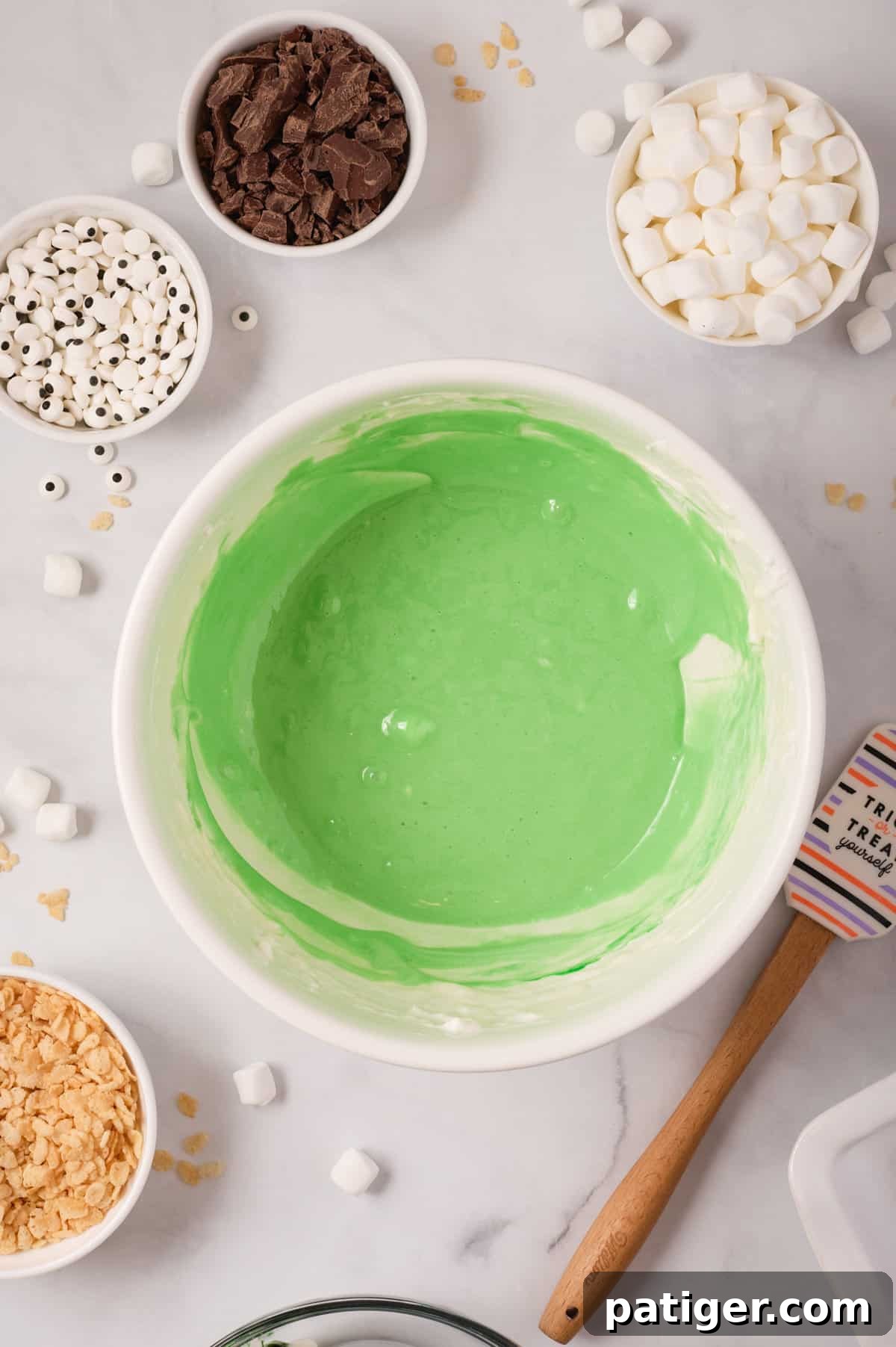 Spooktacular Frankenstein Krispies 6 Green marshmallow mixture in bowl.