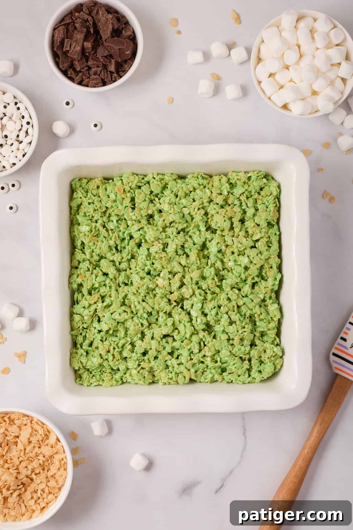 Spooktacular Frankenstein Krispies 8 Green cereal mixture in pan.