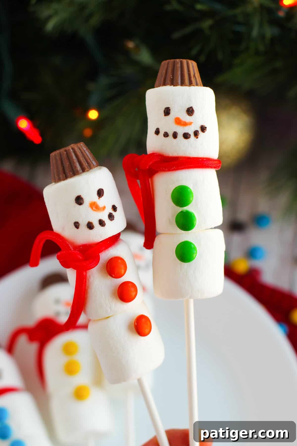 A cheerful assembly of Marshmallow Snowman Kebabs, adorned with candy accessories.