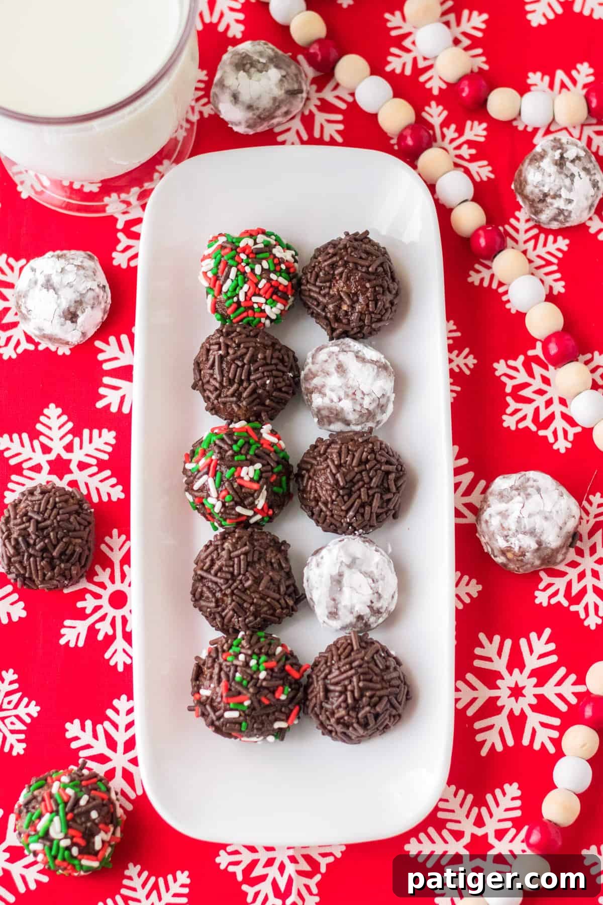 Tray of Christmas rum balls with glass of milk.