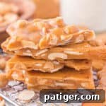 Another enticing close-up of homemade nut brittle, showcasing its golden hue and the delicious mix of almonds and peanuts.