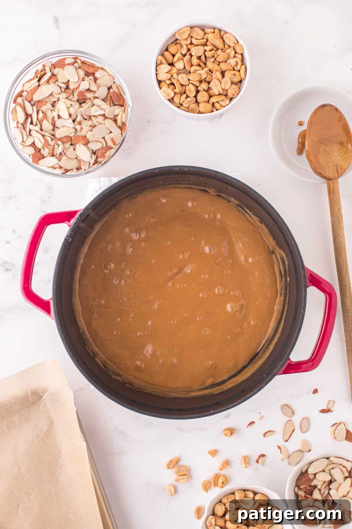 The caramelized sugar mixture in a large pot, having just reached the hard crack stage and ready for the nuts to be added, showing a rich golden hue.