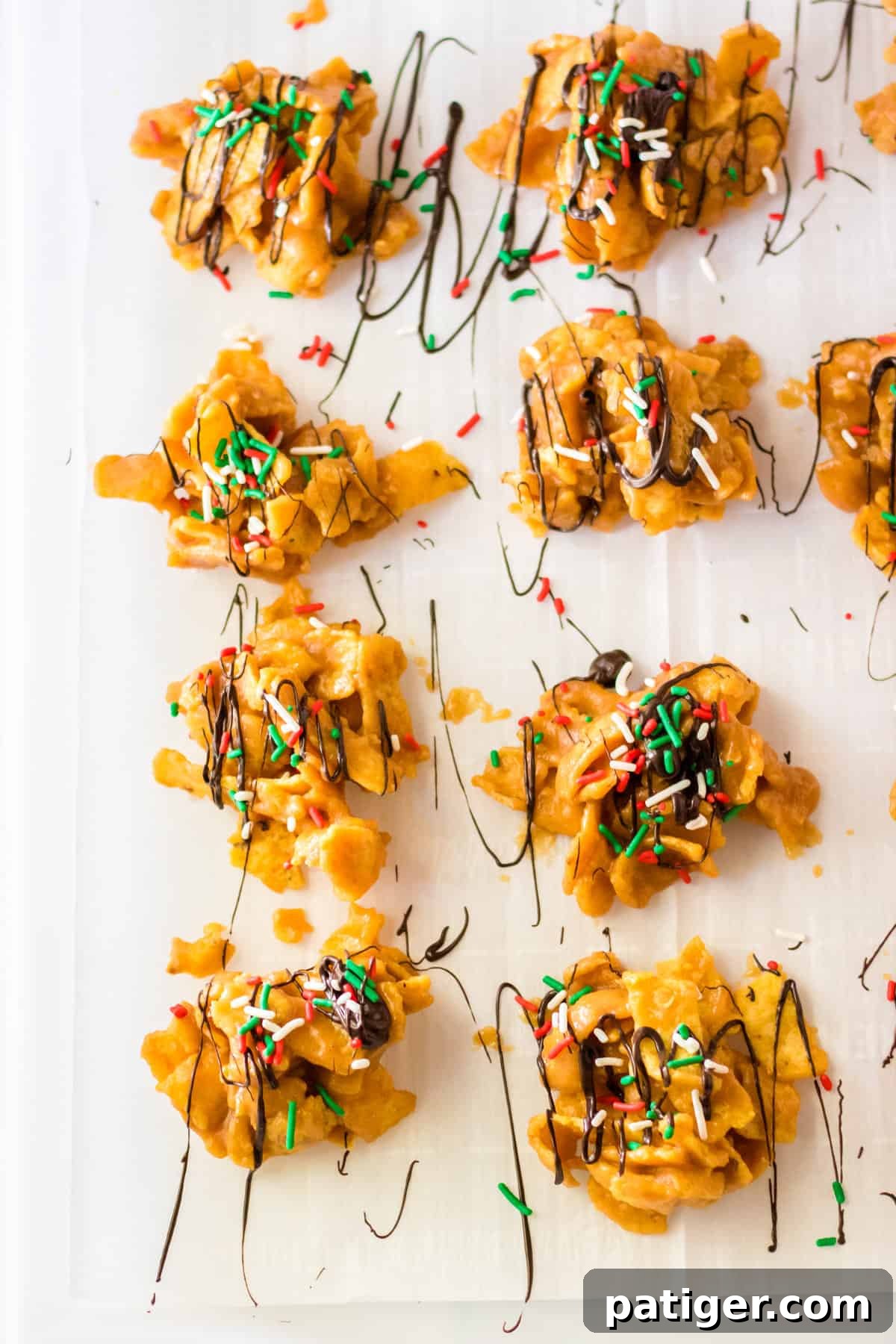 Fritos candy on parchment paper topped with chocolate drizzle and sprinkles.