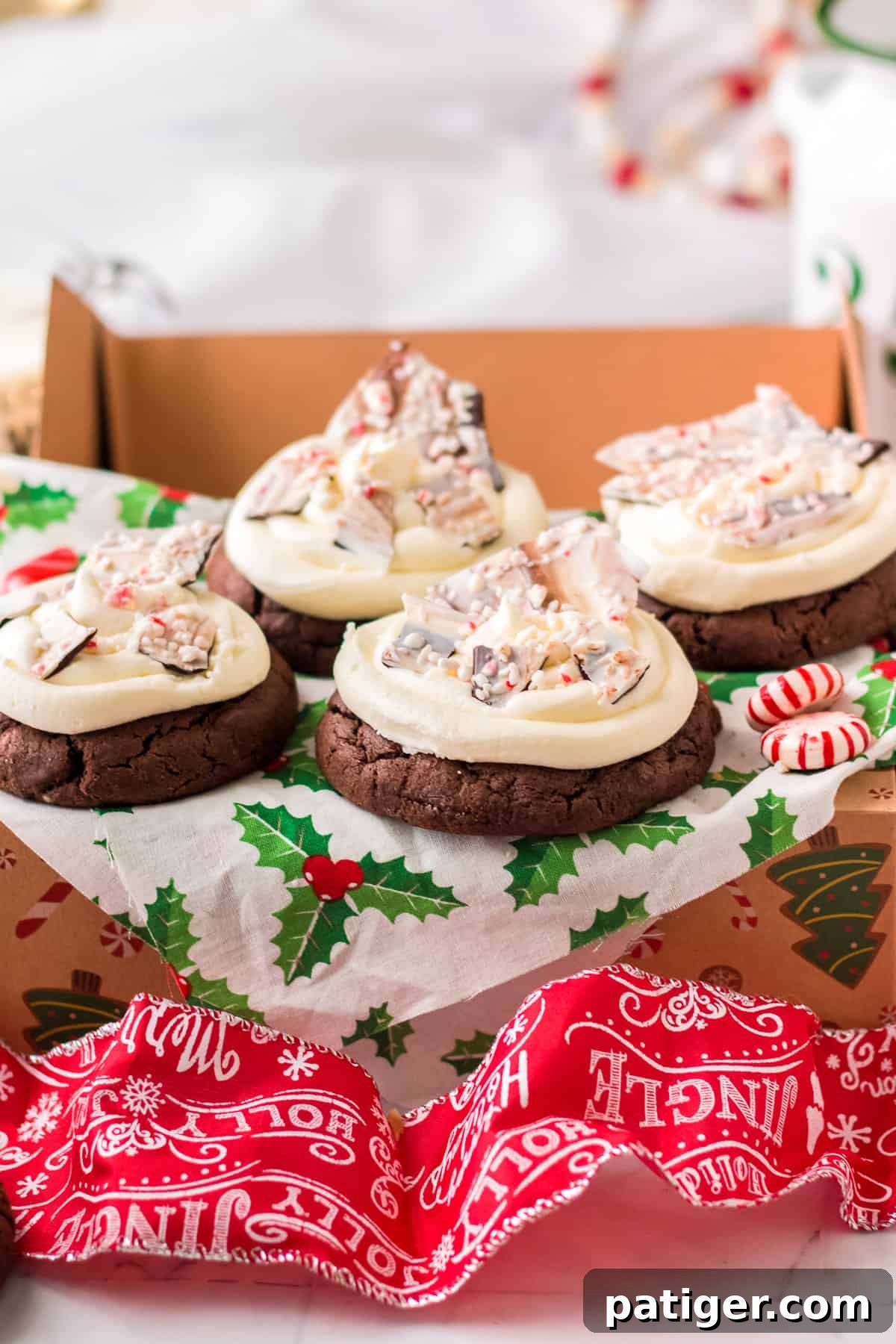 Chocolate peppermint bark cookies in gift box with mistletoe tissue paper.