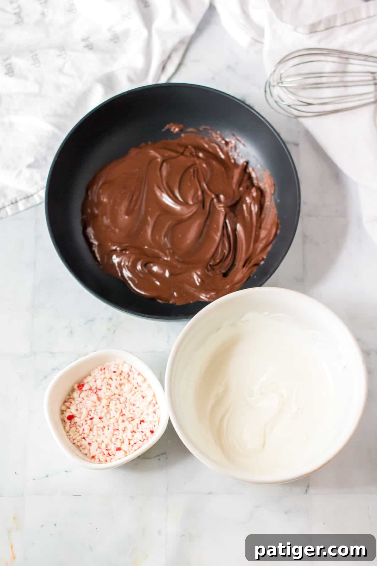 Bowls of melted chocolate, melted white chocolate, and crushed peppermints.