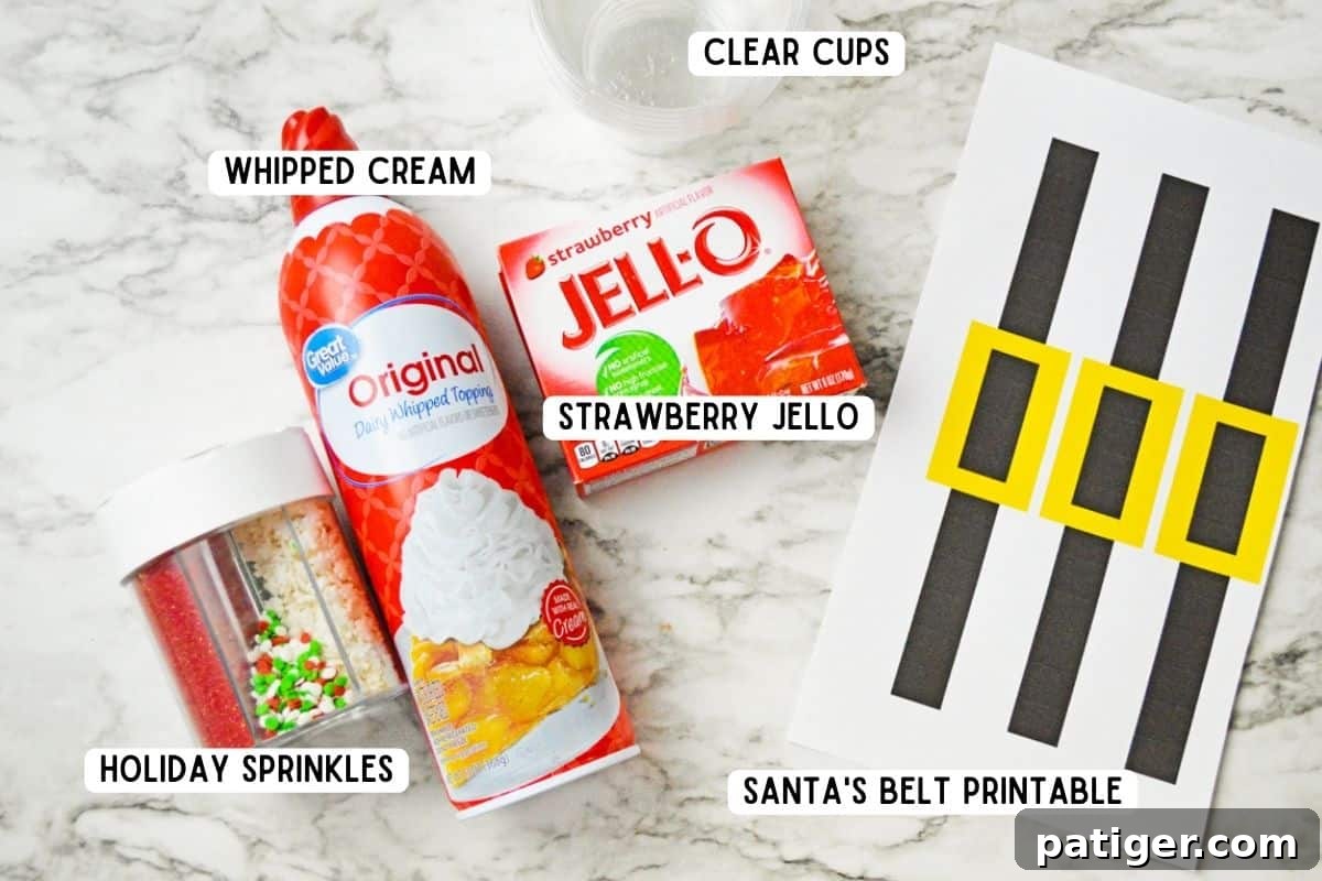 Assortment of ingredients for Santa Jello Cups: Christmas sprinkles, a box of Strawberry Jello, a can of whipped cream, clear plastic cups, and a paper sheet with Santa belt designs.