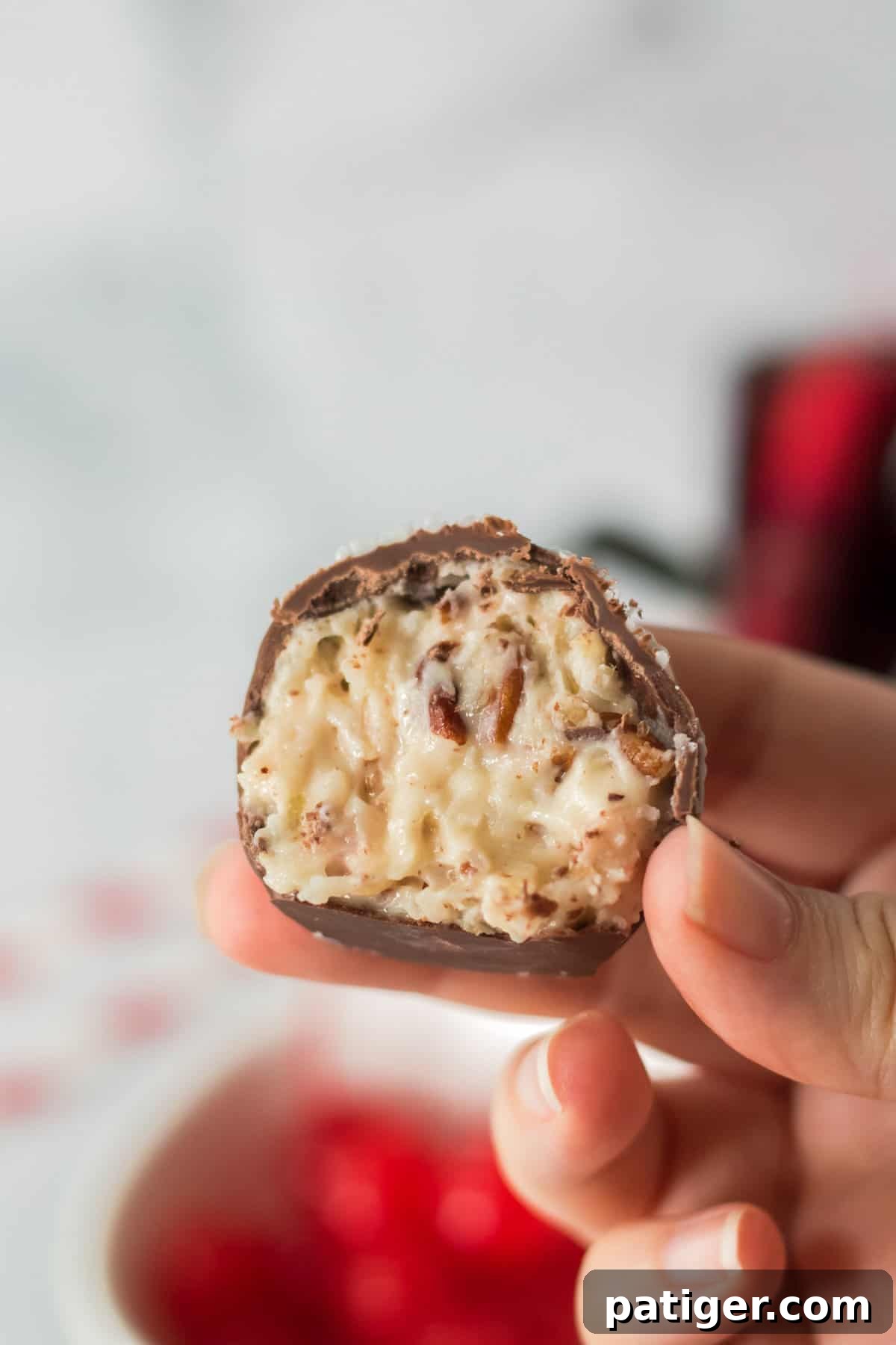 Martha Washington candy cut in half to reveal its creamy, delightful filling of coconut, pecans, and cherries.