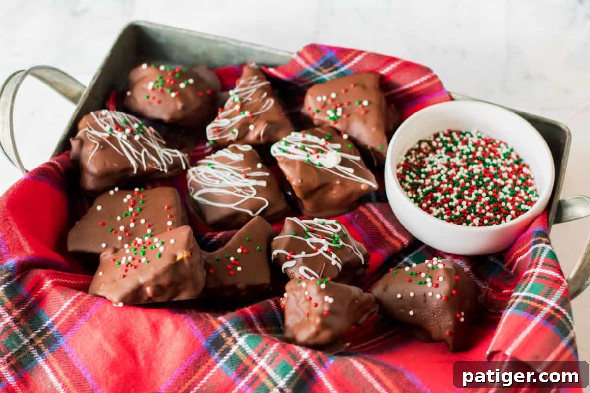 Golden Honeycomb Chocolate Crunch 2 Chocolate coated honeycomb candy in napkin-lined tray with bowl of holiday sprinkles.