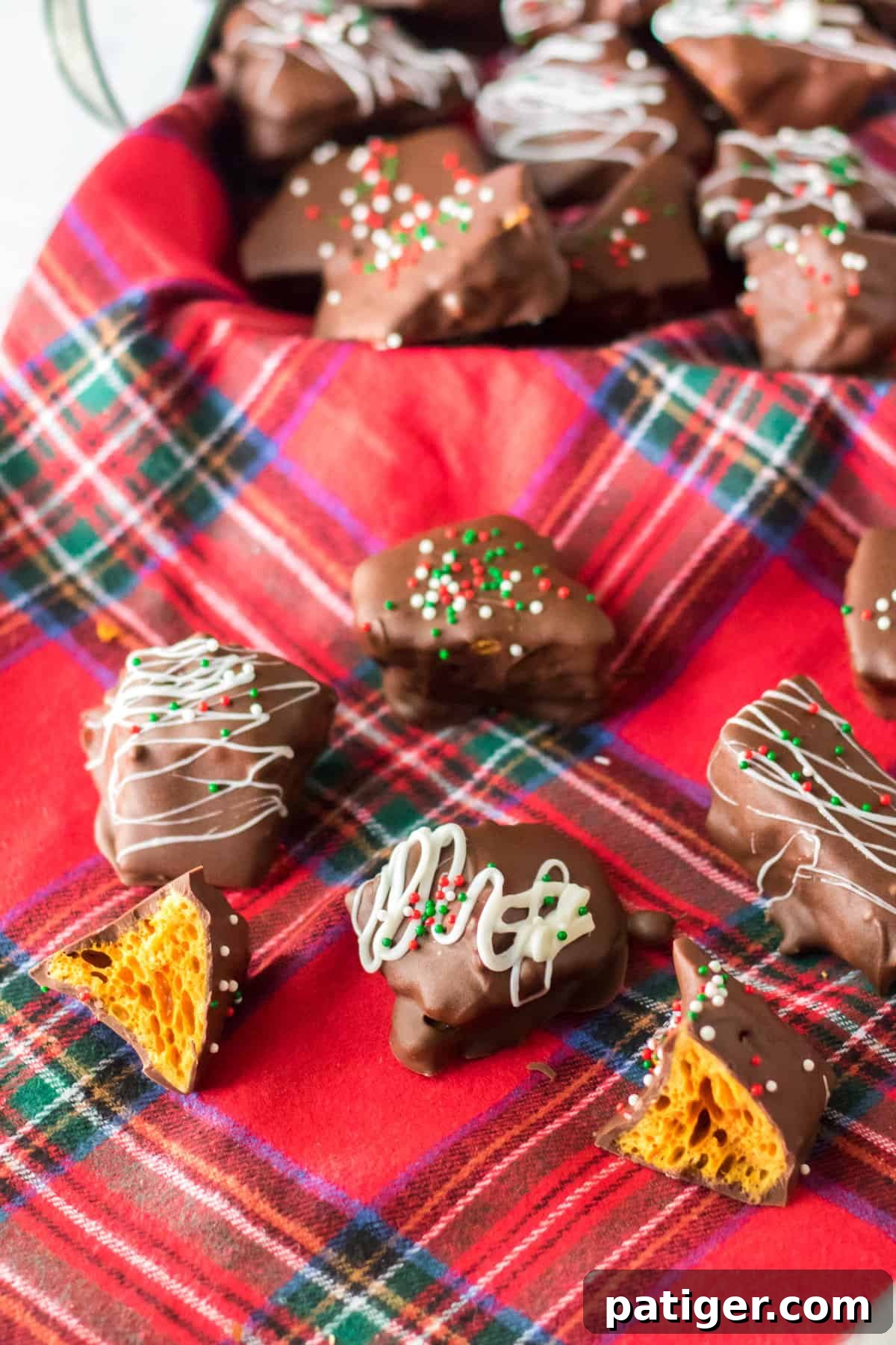 Golden Honeycomb Chocolate Crunch 11 Honeycomb candy coated in chocolate on holiday linen.