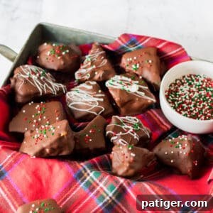 Golden Honeycomb Chocolate Crunch 12 Honeycomb candy coated in chocolate and topped with white chocolate drizzle and Christmas sprinkles.