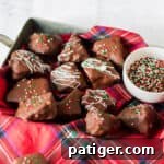 Golden Honeycomb Chocolate Crunch 13 Honeycomb candy coated in chocolate and topped with white chocolate drizzle and Christmas sprinkles.