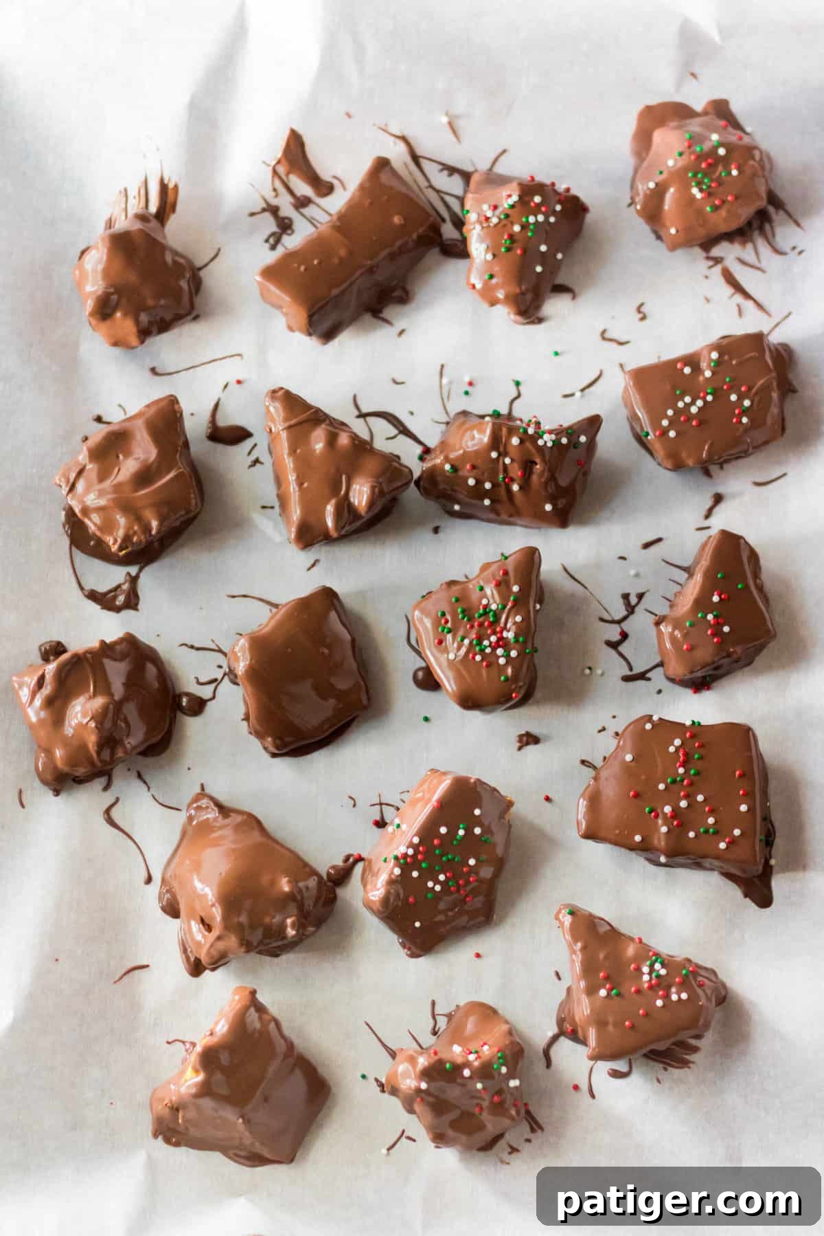 Golden Honeycomb Chocolate Crunch 10 Chocolate covered honeycomb candy pieces on parchment paper.