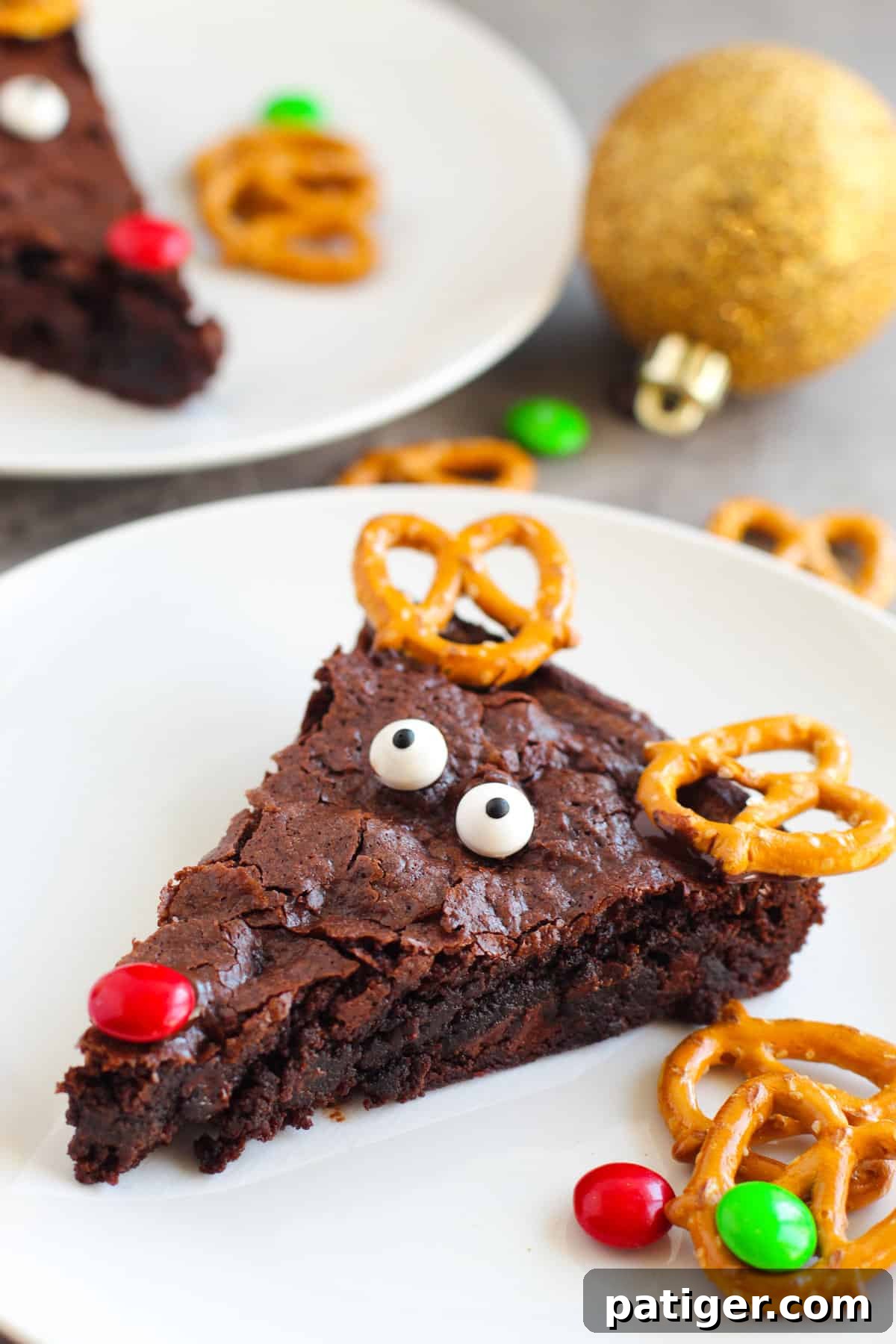 Festive Reindeer Brownies decorated with crunchy pretzel antlers, sweet candy eyes, and a bright red M&M nose, perfect for Christmas celebrations.